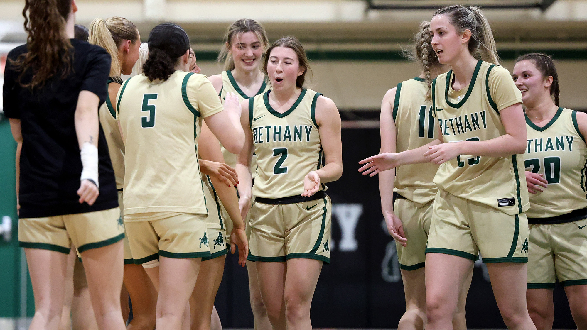 Lindsey Garrison celebrates with teammates after becoming the 19th member of the Bethany College women's basketball 1,000-point club. (GREG PAYAN)